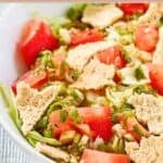Homemade green jacket salad and dressing in a large bowl.