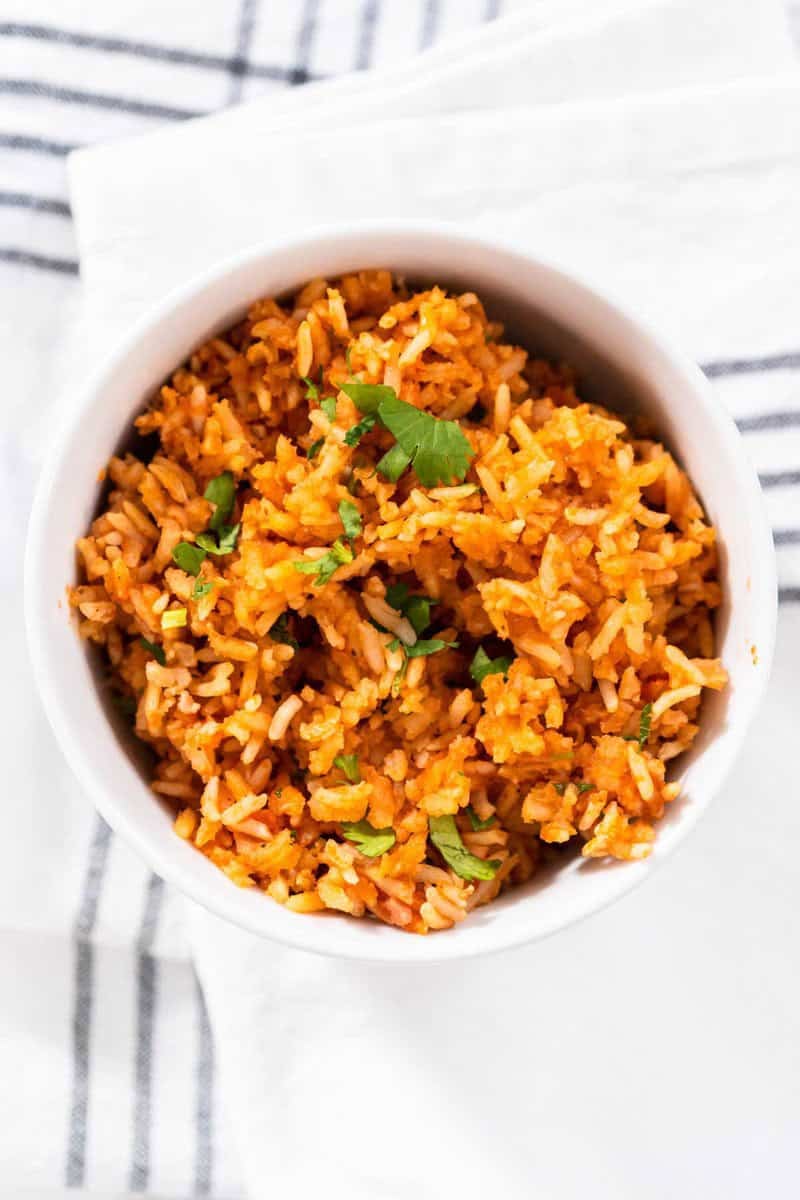 Copycat Guadalajara Spanish rice in a bowl on top of a kitchen towel.