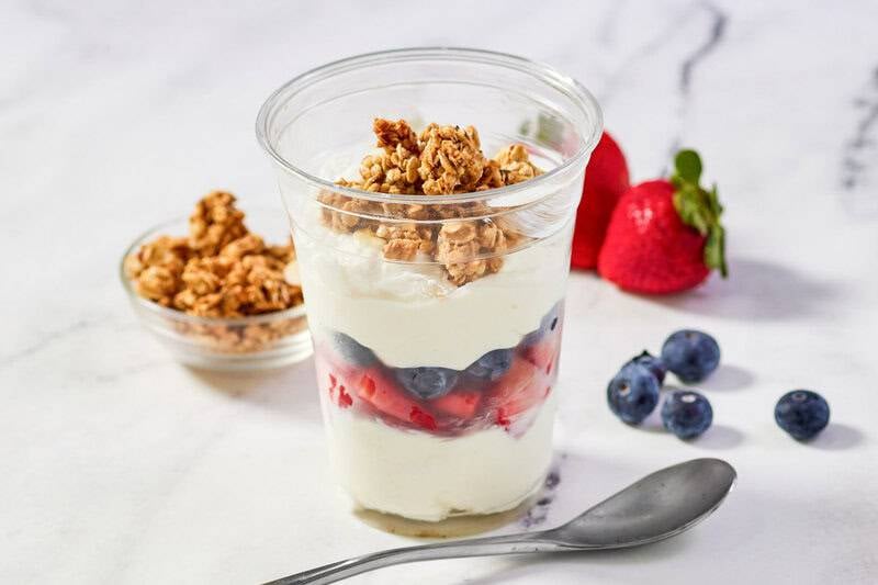 Copycat McDonald's fruit and yogurt parfait, a spoon, berries, and granola.