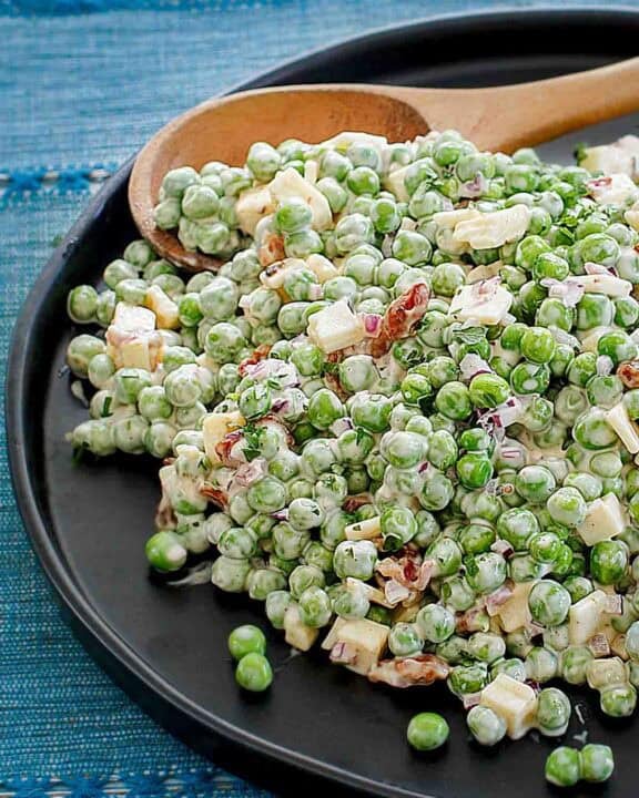 Pea salad with bacon and cheese on a plate.
