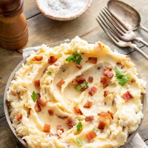 Copycat Ponderosa Steakhouse loaded mashed potatoes on a wood table.