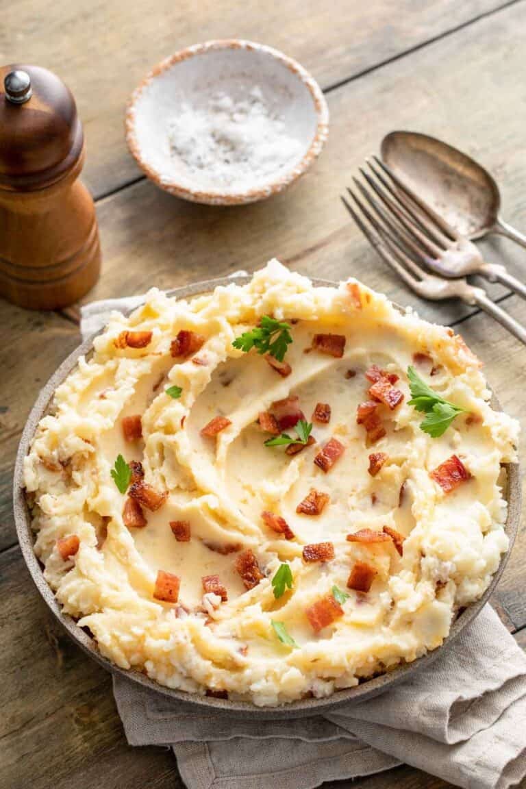 Copycat Ponderosa Steakhouse loaded mashed potatoes on a wood table.