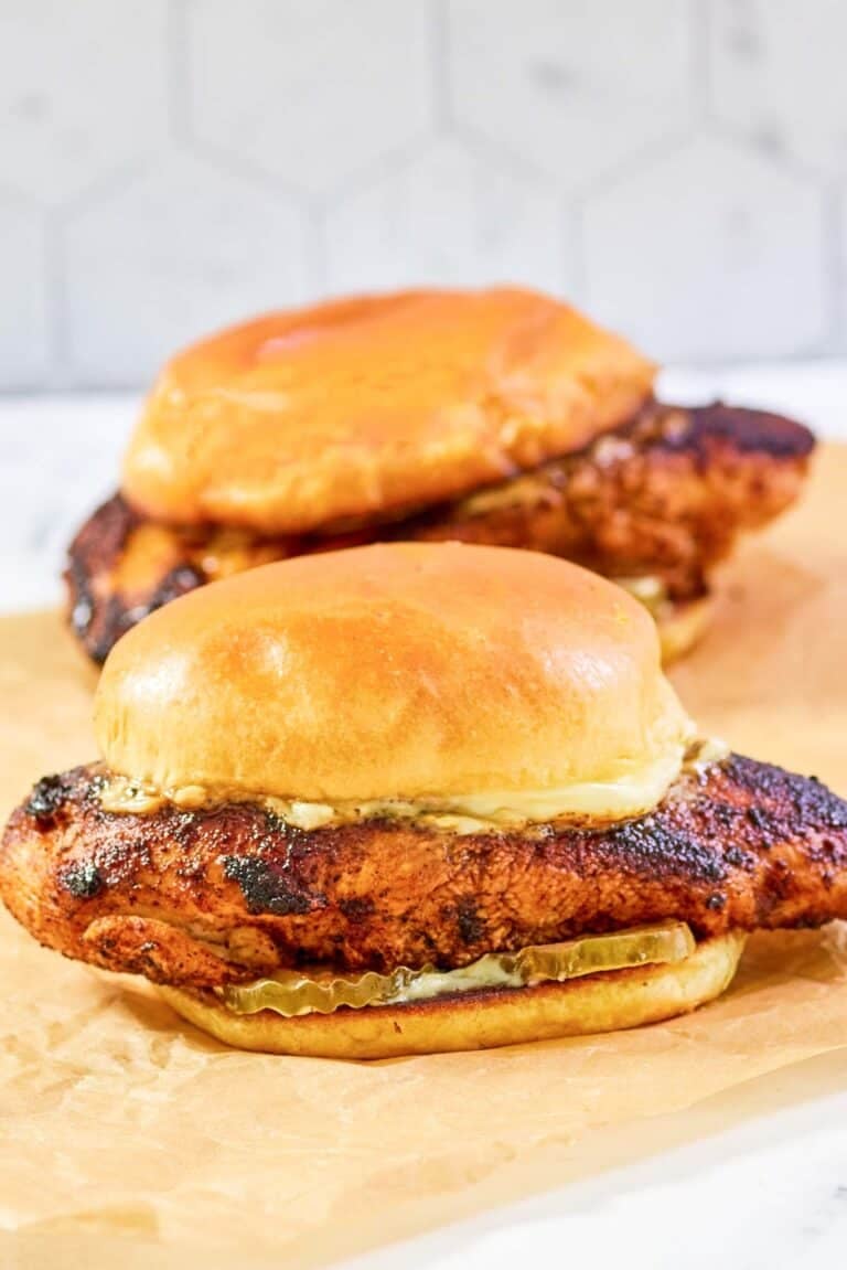 Copycat Popeyes blackened chicken sandwiches with mayo and pickles.