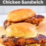 Two homemade Popeyes blackened chicken sandwiches on parchment paper.