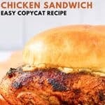 Homemade Popeyes blackened chicken sandwich on parchment paper.