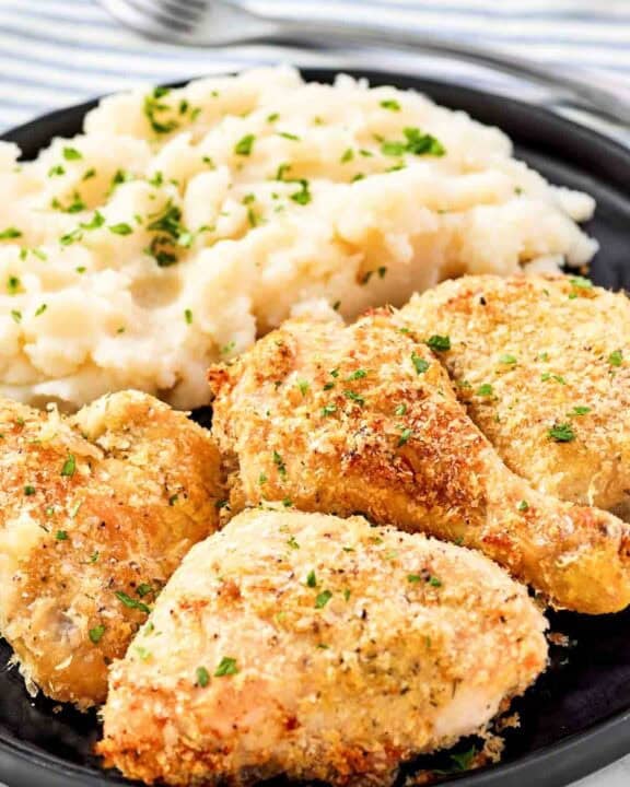 Crispy potato flake chicken and mashed potatoes on a plate.