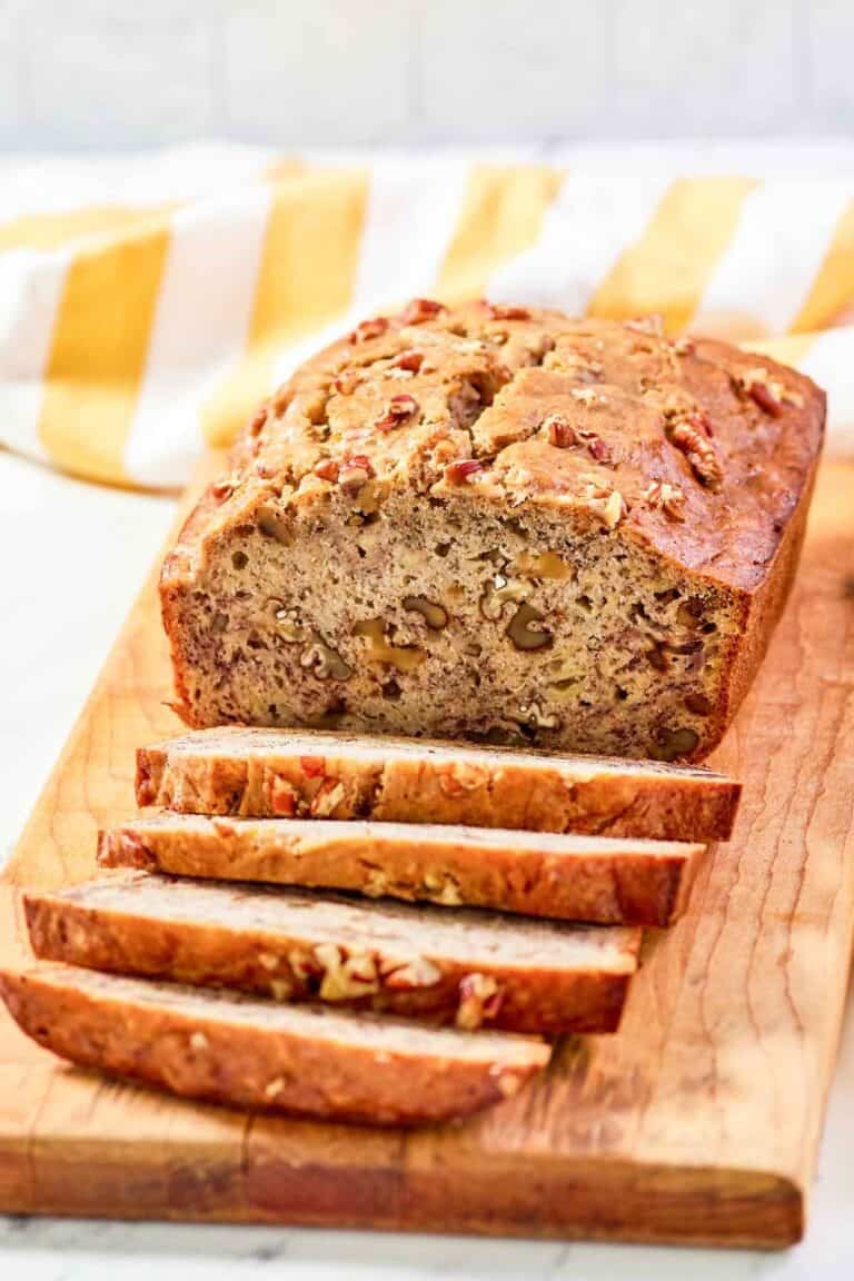 Copycat Starbucks banana walnut and pecan bread loaf on a wood board.