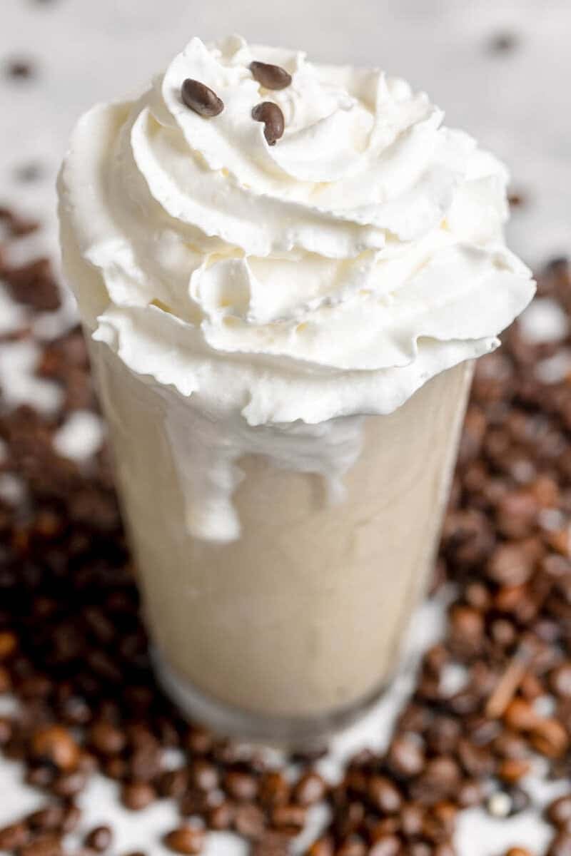 Copycat Chick-fil-A frosted coffee and coffee beans scattered around it.