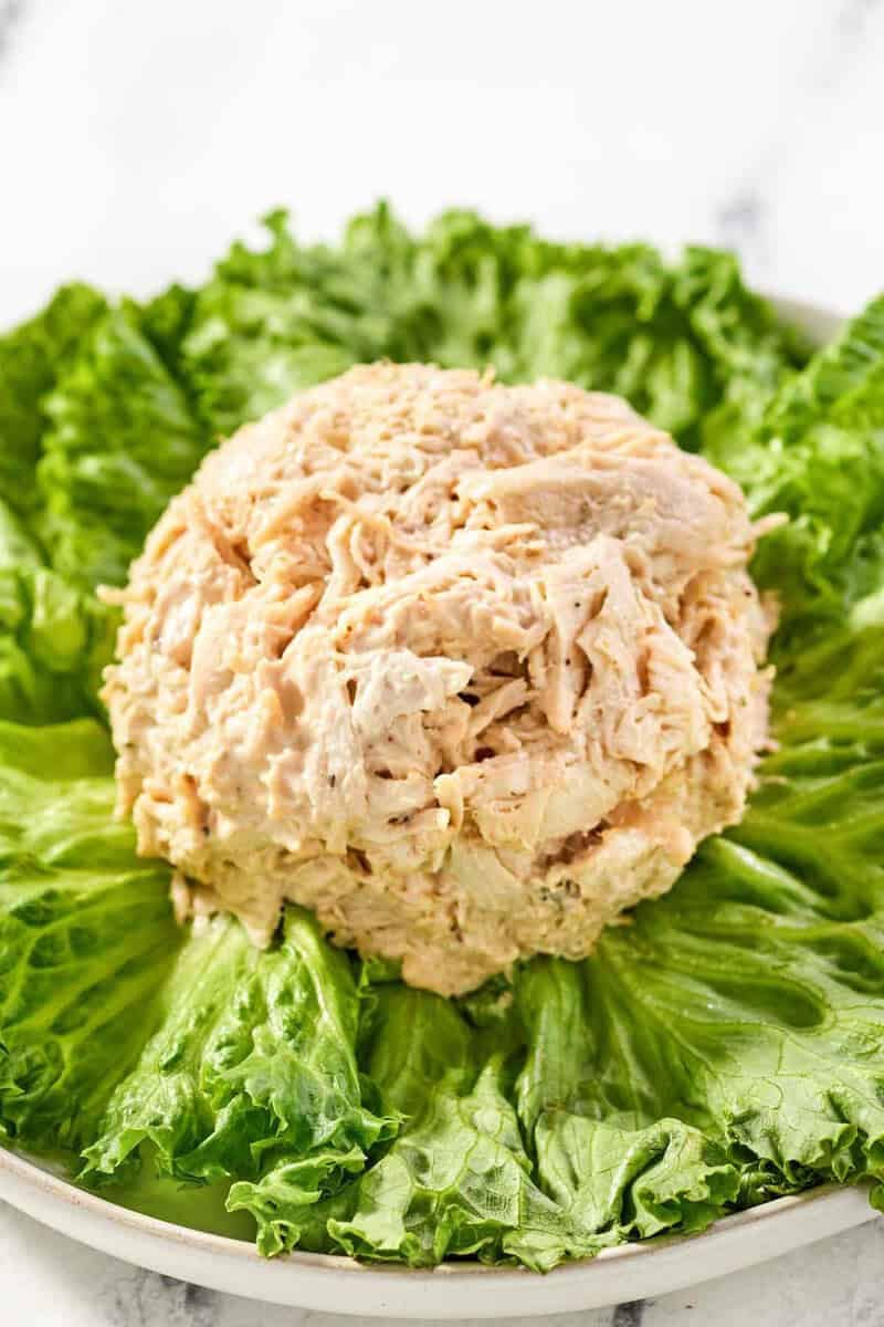 Copycat chicken salad chick barbie-q chicken salad over lettuce on a plate.