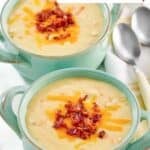 Two bowls of homemade Jason's Deli Irish potato soup in two soup crocks.
