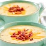 Homemade Jason's Deli Irish potato soup garnished with cheese and bacon.