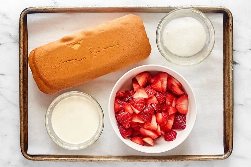 Copycat Jason's Deli strawberry shortcake dessert ingredients on a tray.