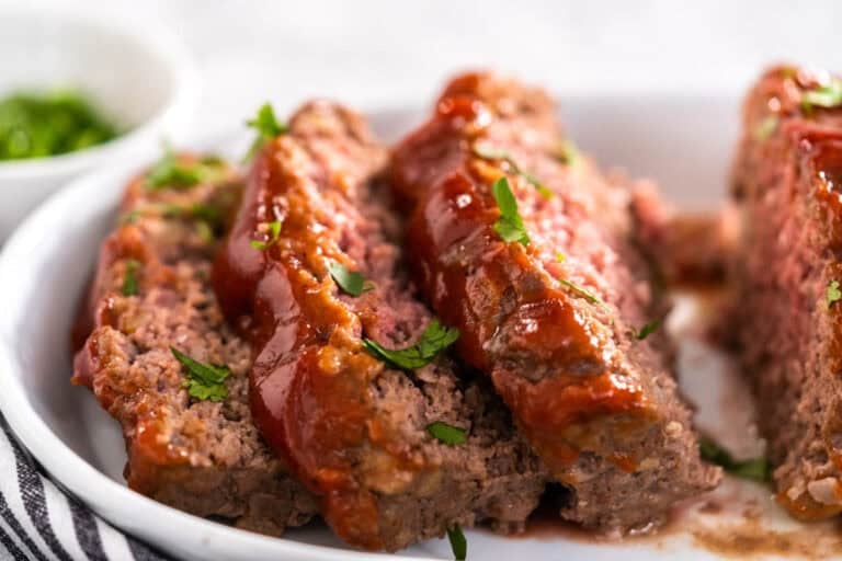 Slices of Mamma Joe's meatloaf garnished with parsley.