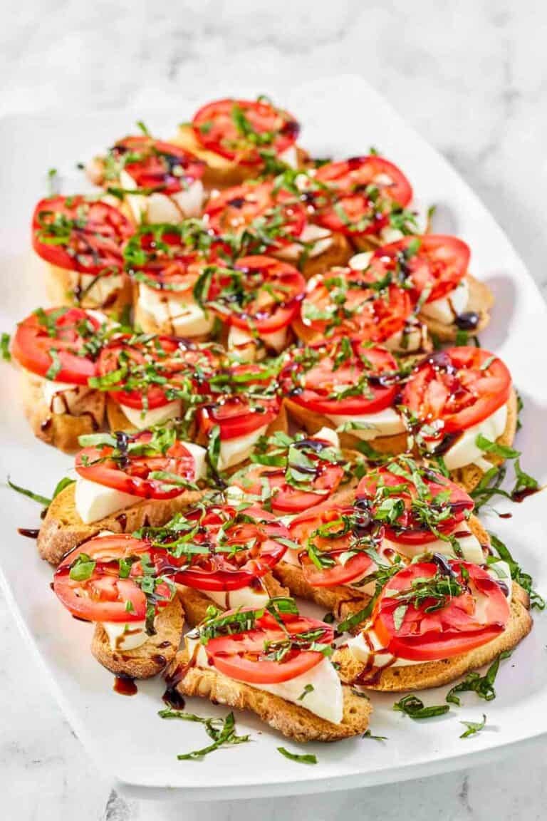 Copycat spaghetti warehouse caprese bruschetta on a marble surface.