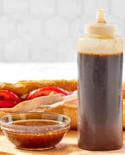 Copycat Subway sweet onion teriyaki sauce in a small bowl and squeeze bottle.