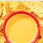 Homemade Taco Bell nacho cheese sauce in a bowl and tortilla chips around it.