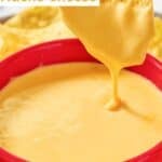 Dipping a tortilla chip in homemade Taco Bell nacho cheese sauce.