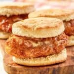 Copycat Wendy's honey butter chicken biscuit on a wood board.