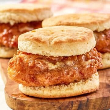 Copycat Wendy's honey butter chicken biscuit on a wood board.