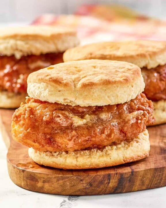 Copycat Wendy's honey butter chicken biscuit on a wood board.