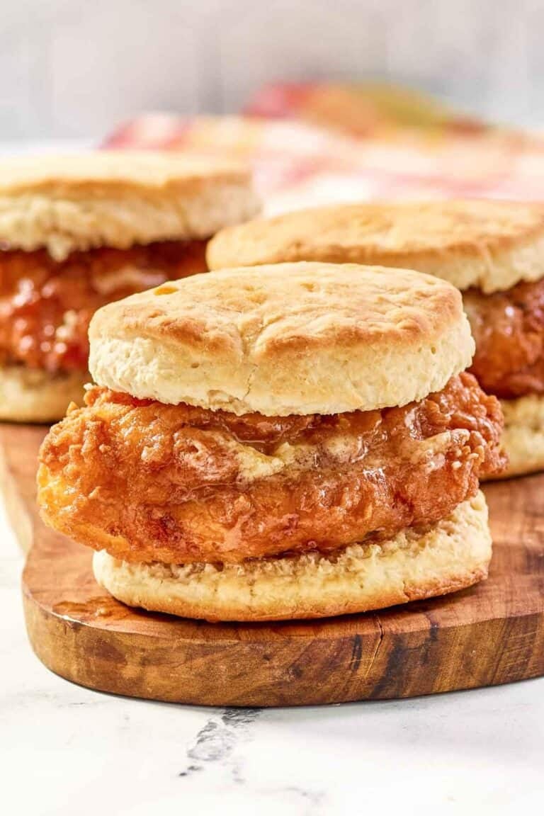 Copycat Wendy's honey butter chicken biscuit on a wood board.