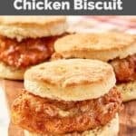 Homemade Wendy's honey butter chicken biscuit sandwiches on a wood board.