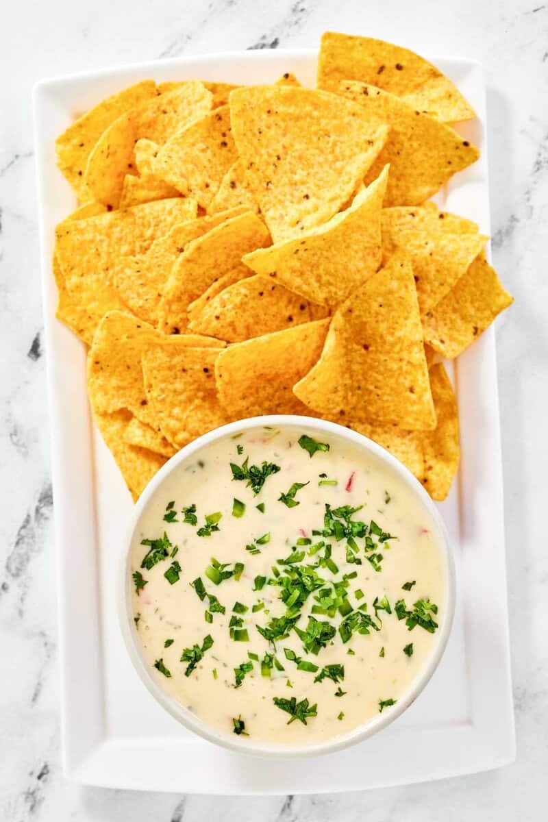 Copycat Applebee's queso blanco dip and tortilla chips on a platter.