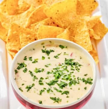 Copycat Applebee's queso blanco dip and tortilla chips on a platter.