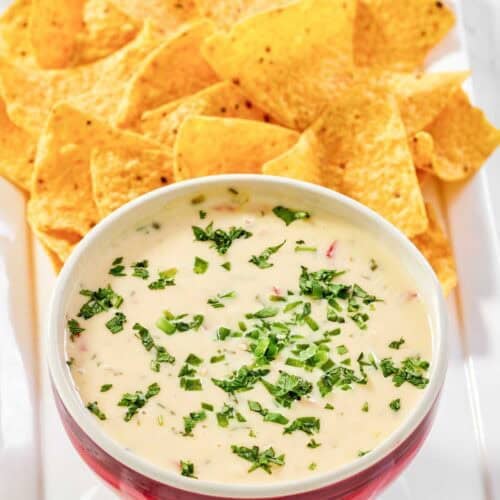 Copycat Applebee's queso blanco dip and tortilla chips on a platter.