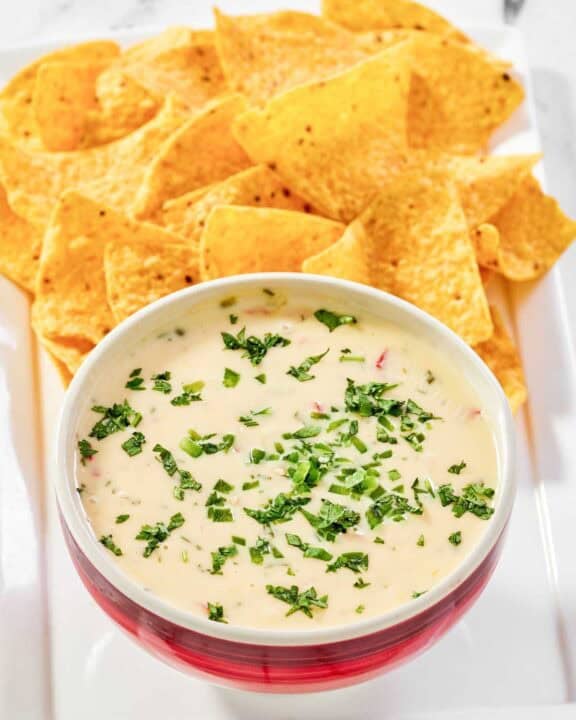 Copycat Applebee's queso blanco dip and tortilla chips on a platter.