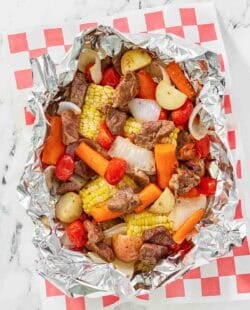 Copycat Cracker Barrel campfire beef meal in foil on parchment paper.