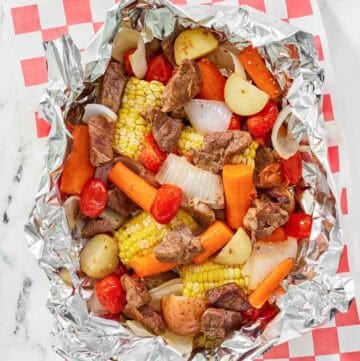 Copycat Cracker Barrel campfire beef meal in foil on parchment paper.
