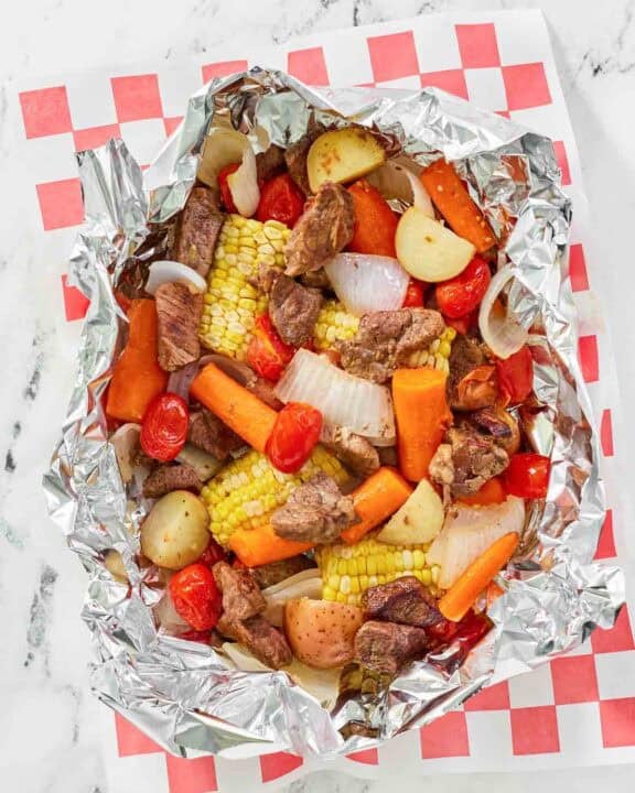 Copycat Cracker Barrel campfire beef meal in foil on parchment paper.