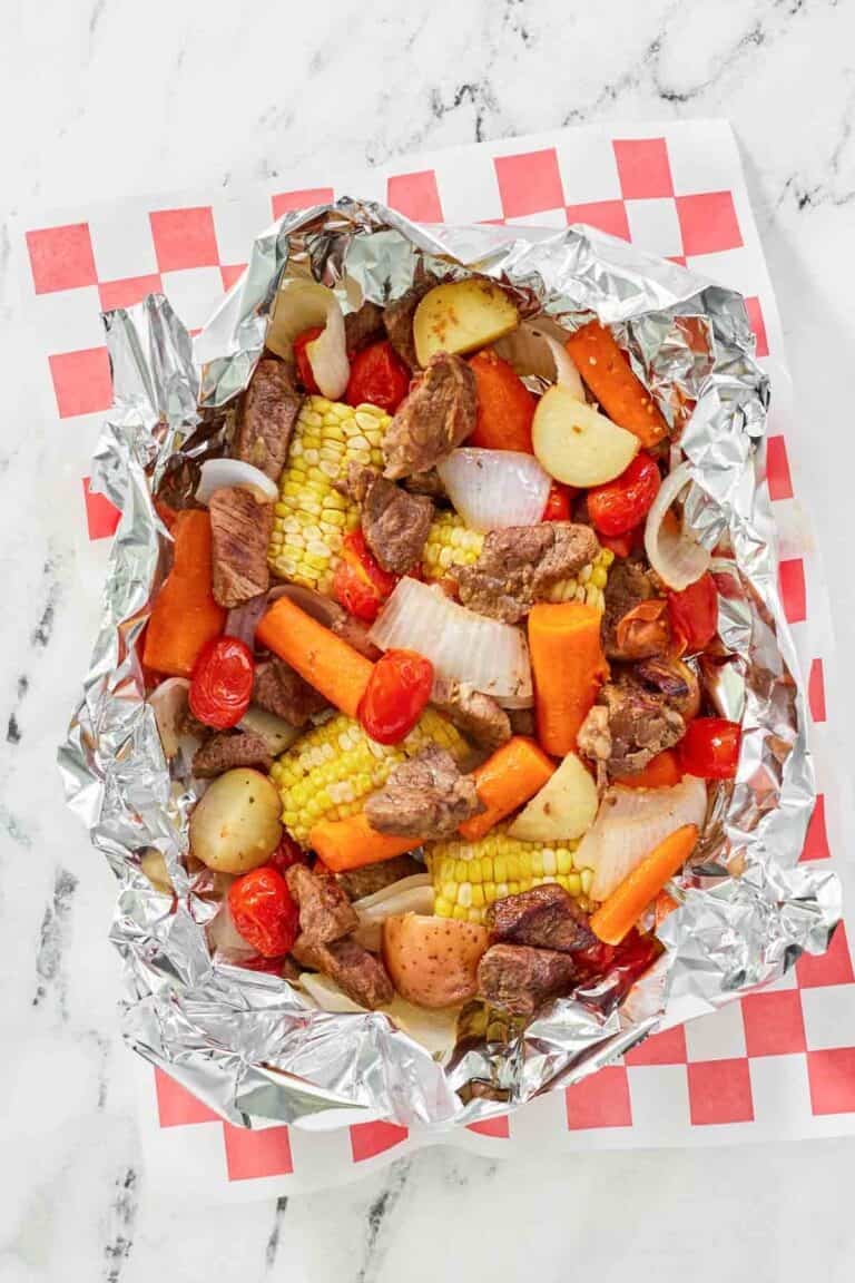Copycat Cracker Barrel campfire beef meal in foil on parchment paper.