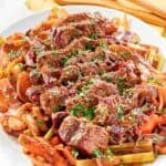 Copycat golden corral pot roast with vegetables and gravy on a platter.