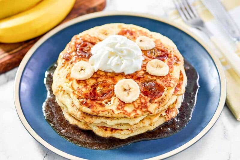 IHOP Bananas Foster Pancakes 24 Copycat IHOP bananas foster pancakes with banana slices, brown sugar syrup, and whipped cream.
