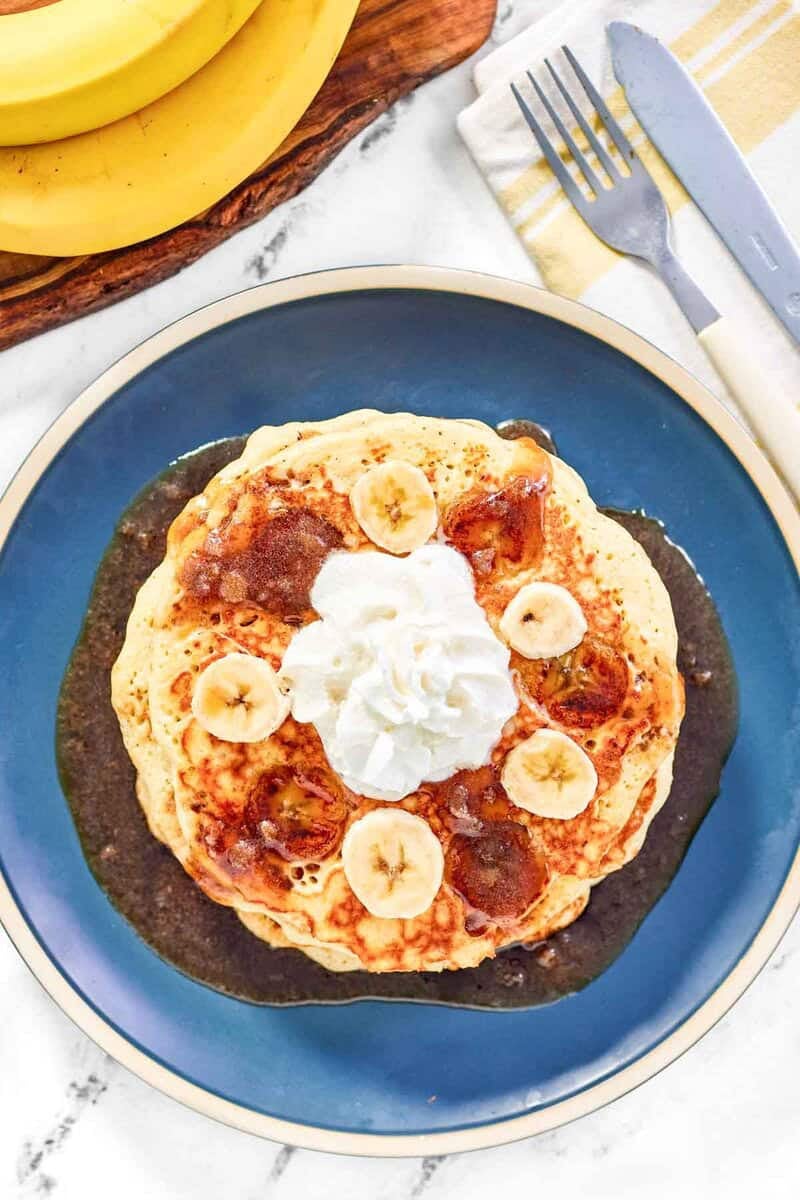 IHOP Bananas Foster Pancakes 26 Copycat IHOP bananas foster pancakes, bananas, fork, and knife.