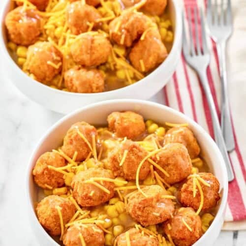 Two copycat KFC famous bowls and two forks on napkins.