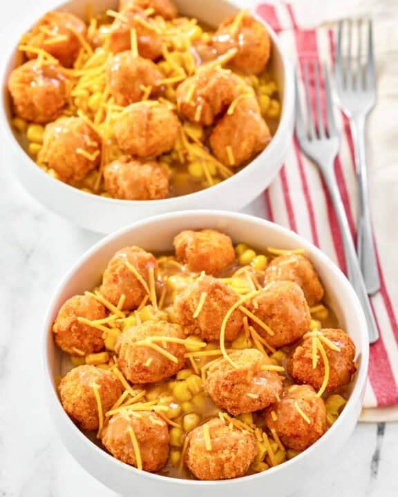Two copycat KFC famous bowls and two forks on napkins.