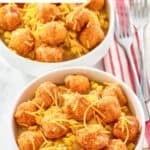 Two homemade KFC famous bowls with mashed potatoes, gravy, corn, and cheese.