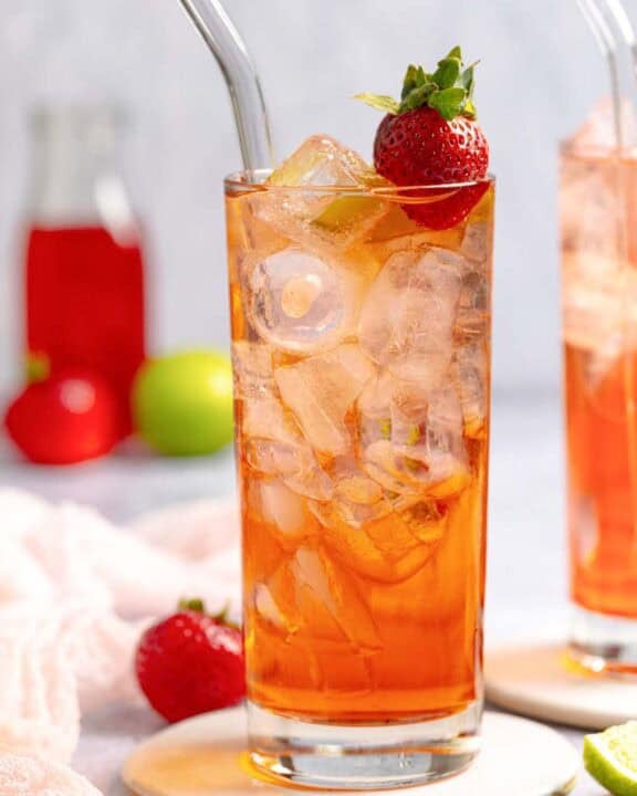 Copycat Sonic strawberry limeade in a tall glass on a coaster.