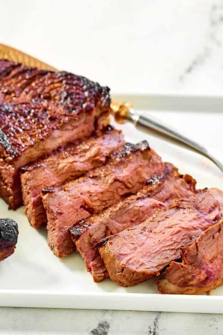 Steak made with copycat steak and ale kensington club marinade on a platter.