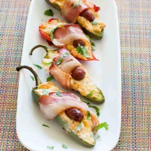 Bacon wrapped little smokie poppers on a platter.