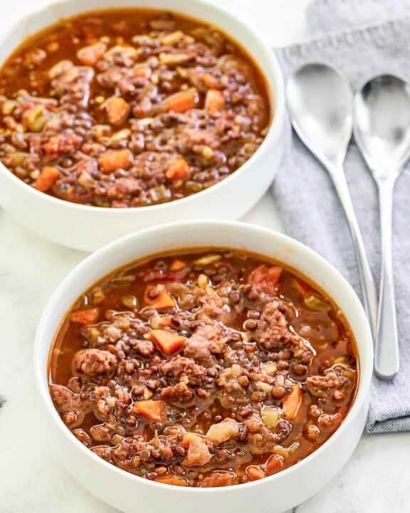 Copycat Carrabba's sausage lentil soup in two bowls.
