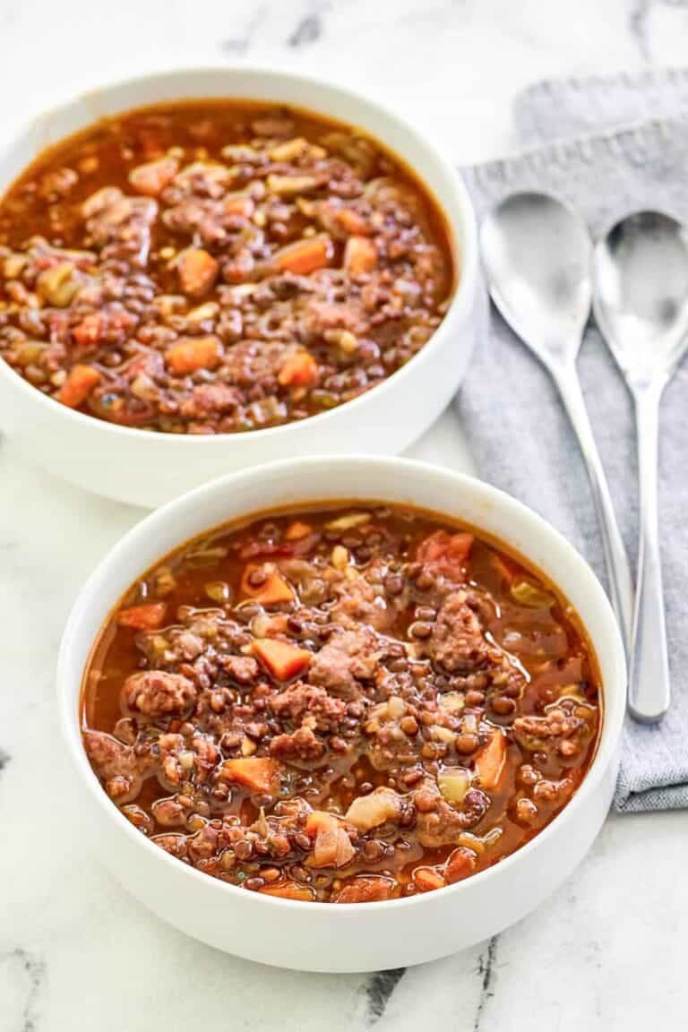 Copycat Carrabba's sausage lentil soup in two bowls.