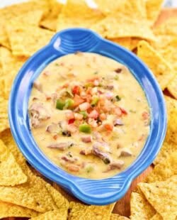 Copycat HEB tex-mex brisket queso dip with tortilla chips.