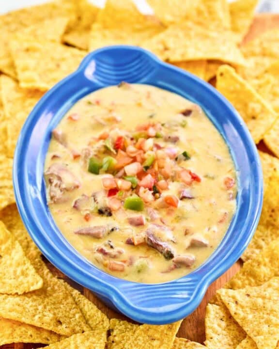 Copycat HEB tex-mex brisket queso dip with tortilla chips.