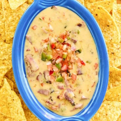 Copycat HEB brisket queso dip served with tortilla chips.