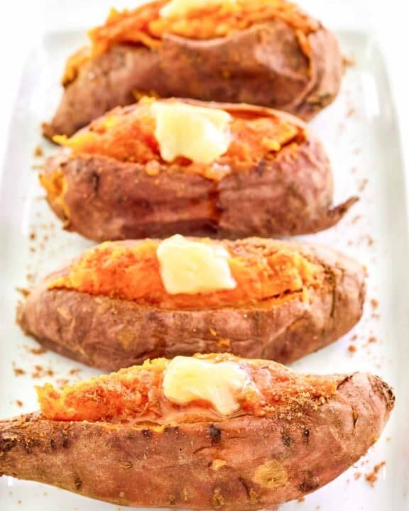 Copycat Outback Steakhouse baked sweet potatoes with honey butter and brown sugar.