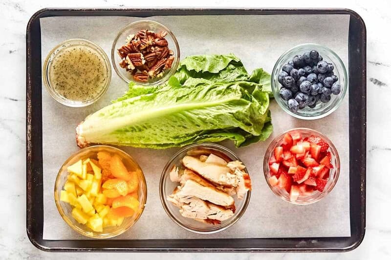 Copycat Panera strawberry poppyseed chicken salad ingredients on a tray.